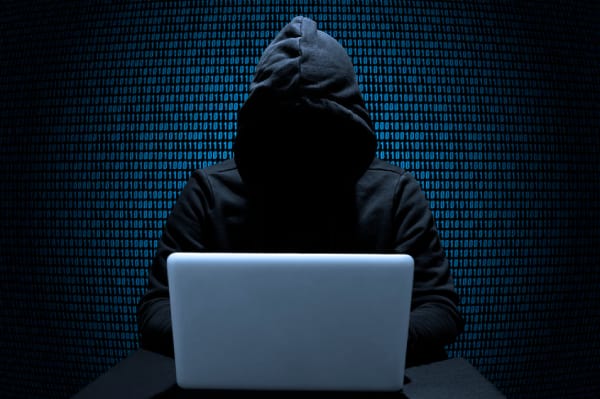 Hacker attempting WiFi hack to steal data from unsecured networks