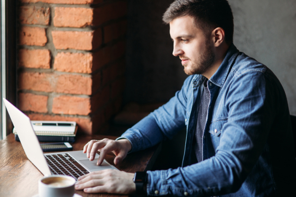 Remote worker using HIPAA compliant email securely on laptop