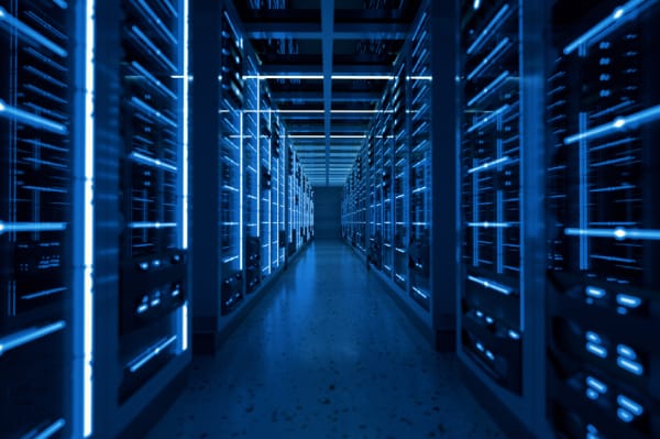 Rows of illuminated server racks in a secure data center, symbolizing the infrastructure behind website hosting and the importance of securing server environments to prevent hacks.