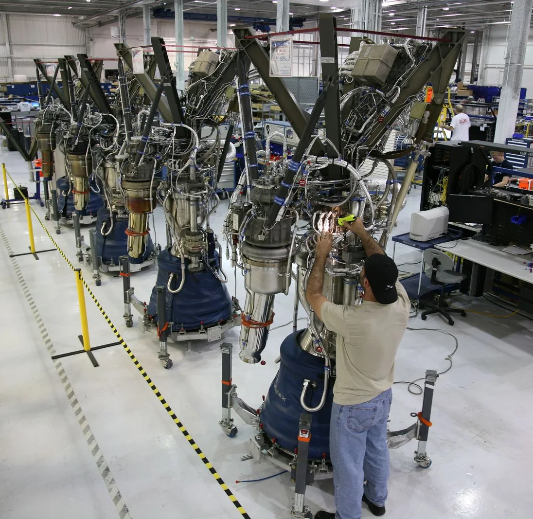 Technician assembling precision components on an aerospace manufacturing line
