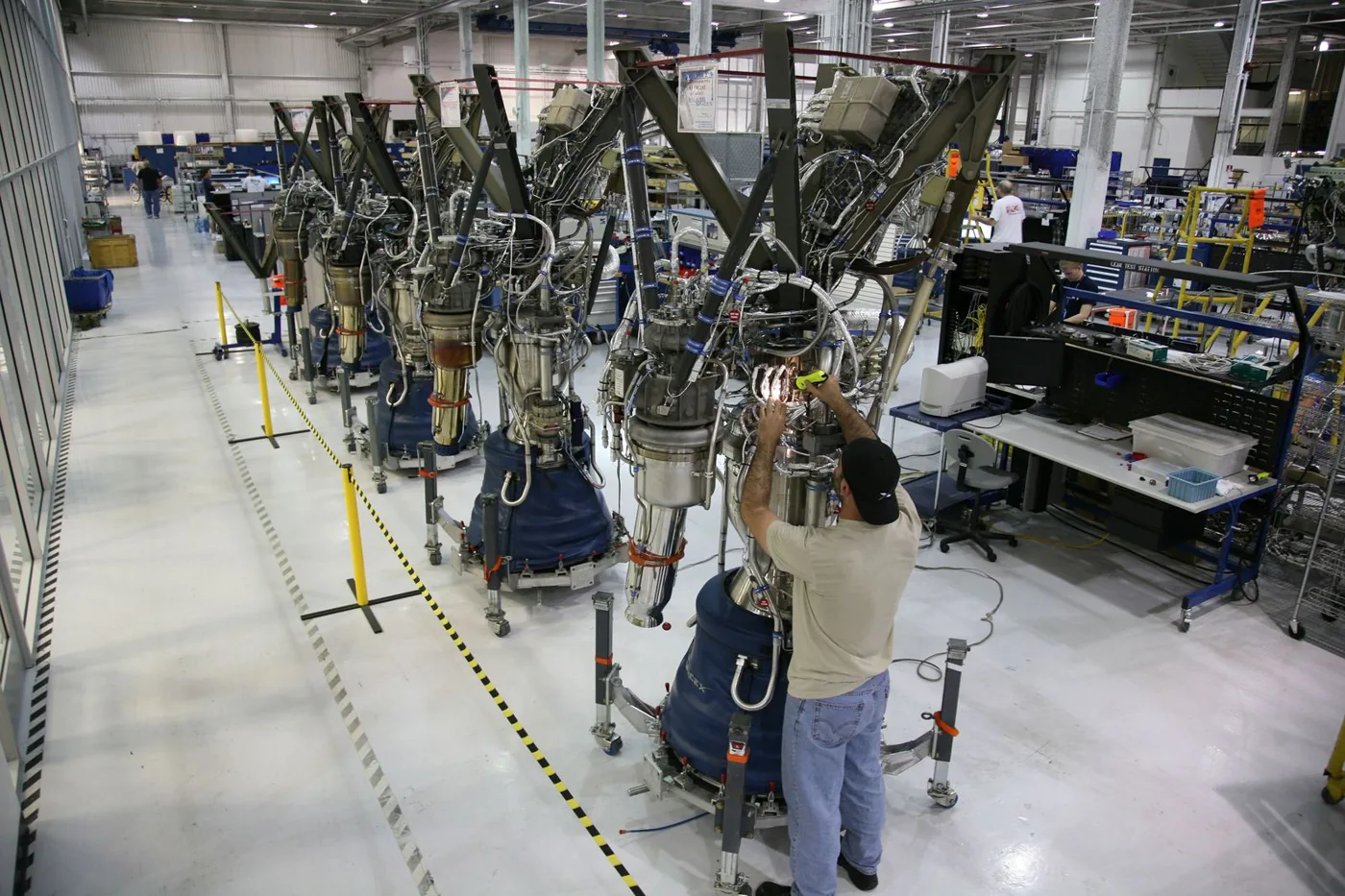 Technician assembling precision components on an aerospace manufacturing line