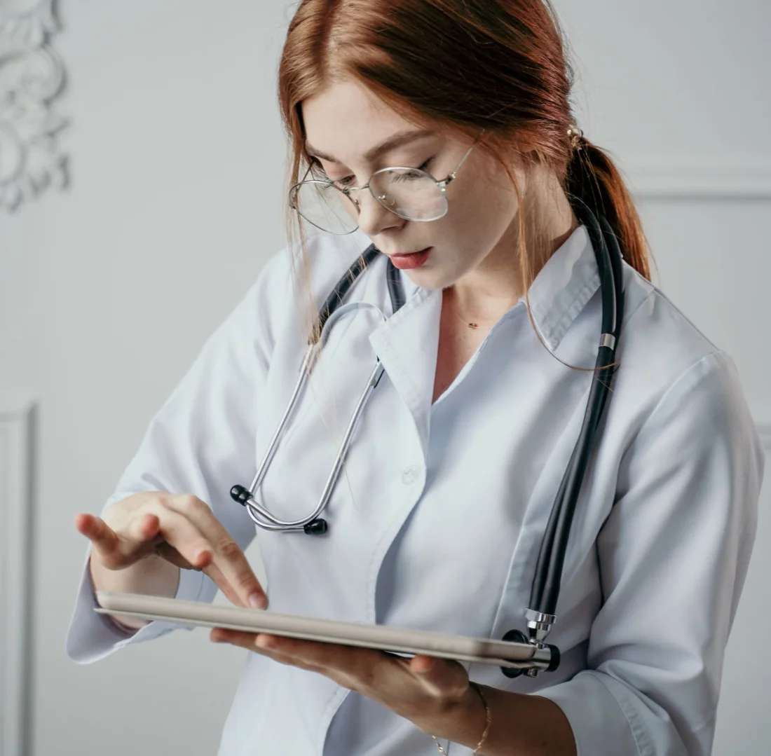 Clinician reviewing patient information on a tablet in a clinical setting