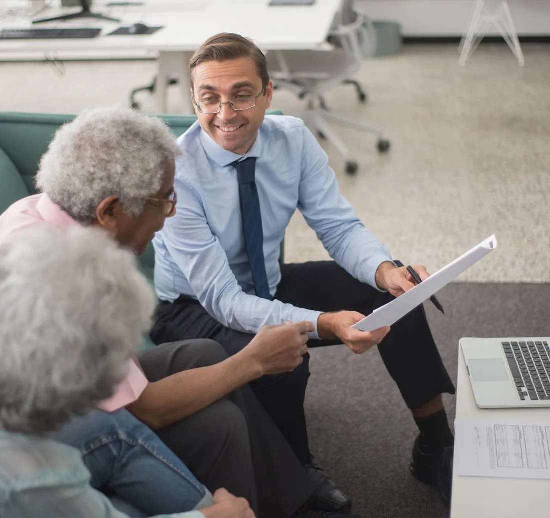 Financial advisor reviewing a financial plan with clients in an office