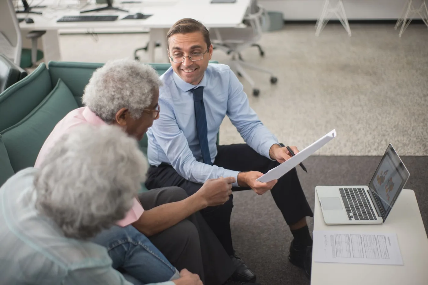 Financial advisor reviewing a financial plan with clients in an office