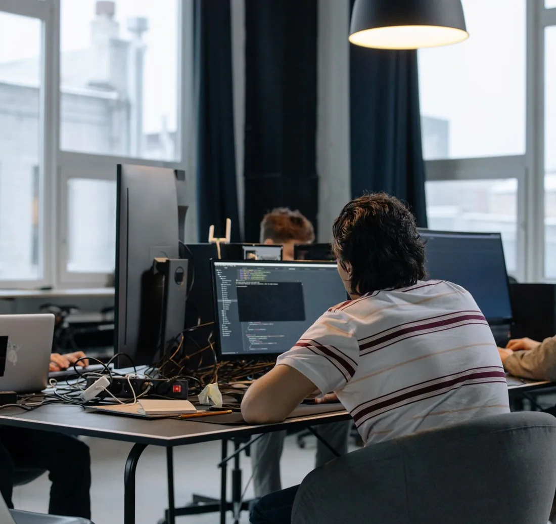 Software development team writing code in a modern office
